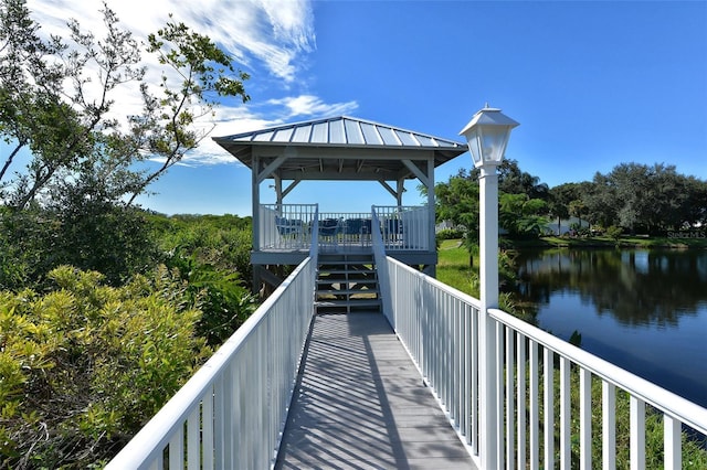 surrounding community with a gazebo and a water view