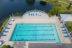 view of swimming pool with a patio and a water view