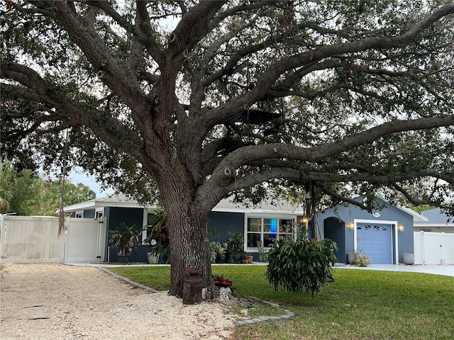 view of front of property featuring a garage and a front lawn