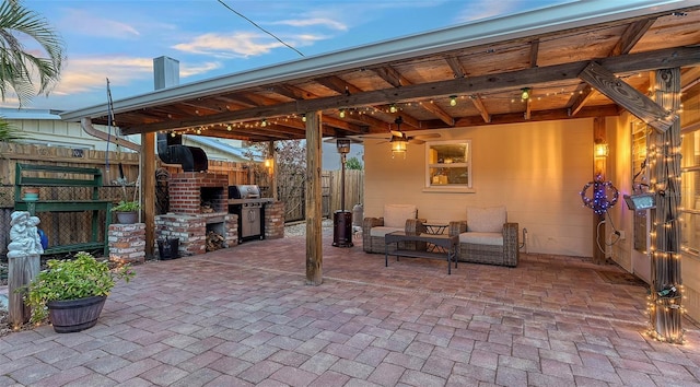 view of patio featuring fence, exterior kitchen, and area for grilling