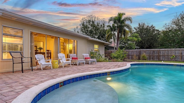 view of swimming pool featuring a fenced in pool, fence, and a patio