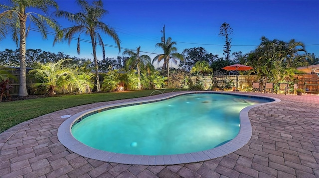 view of pool featuring a yard, fence, and a patio