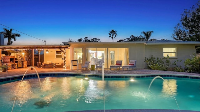 pool with a patio area and an outdoor hangout area