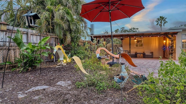 view of play area with a patio area, fence, and a ceiling fan