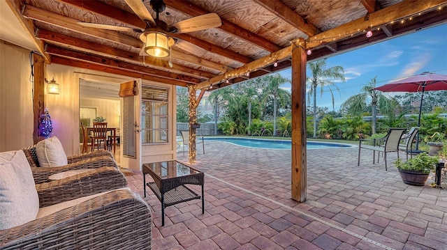 exterior space with an outdoor pool, fence, and ceiling fan