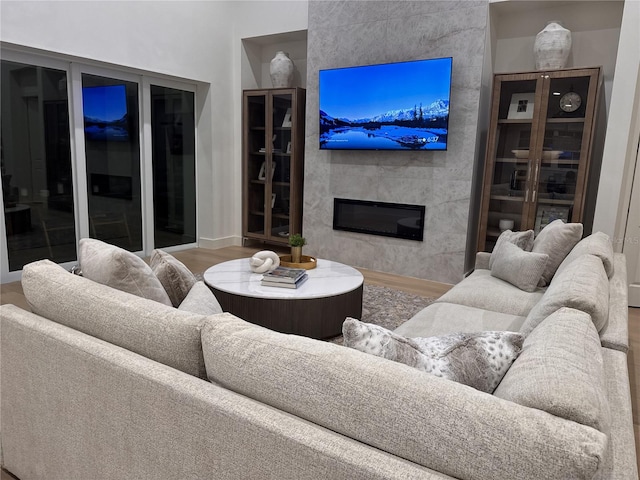 living room with wood-type flooring and a fireplace