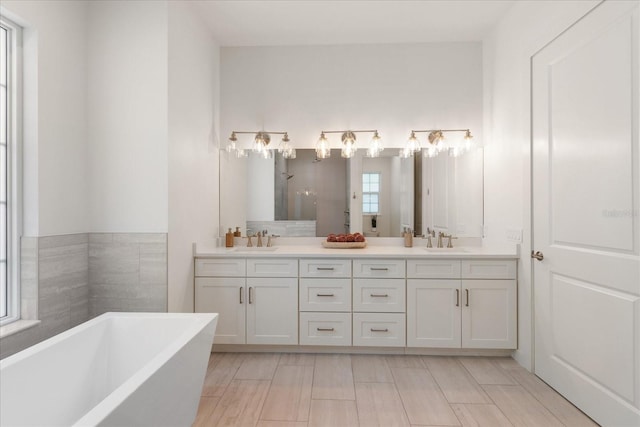 bathroom with a bath and vanity