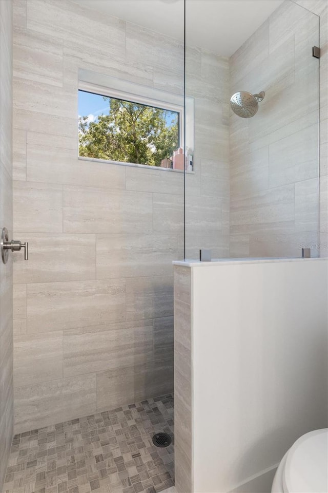 bathroom with tiled shower