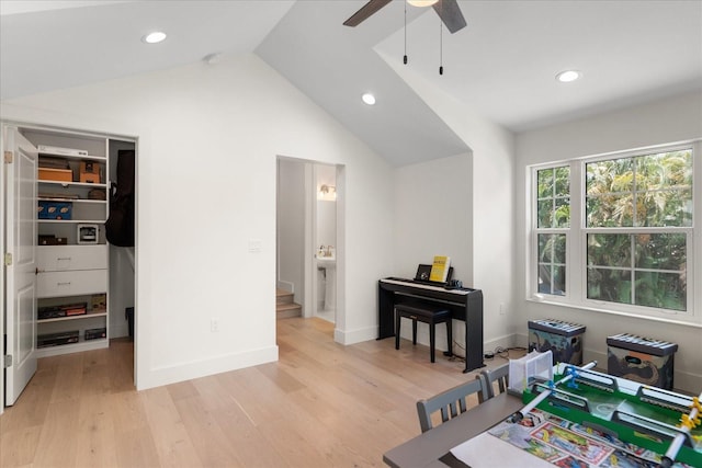 recreation room featuring ceiling fan, light hardwood / wood-style floors, and lofted ceiling