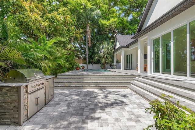 view of patio with a fenced in pool and area for grilling