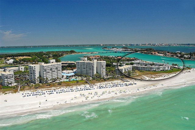 birds eye view of property featuring a water view and a view of the beach