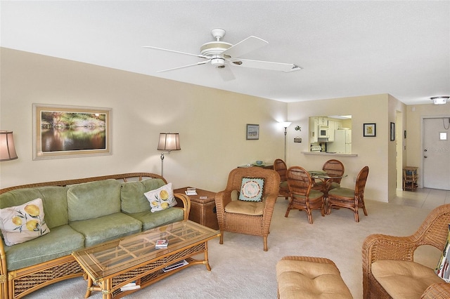 living room featuring ceiling fan and light colored carpet