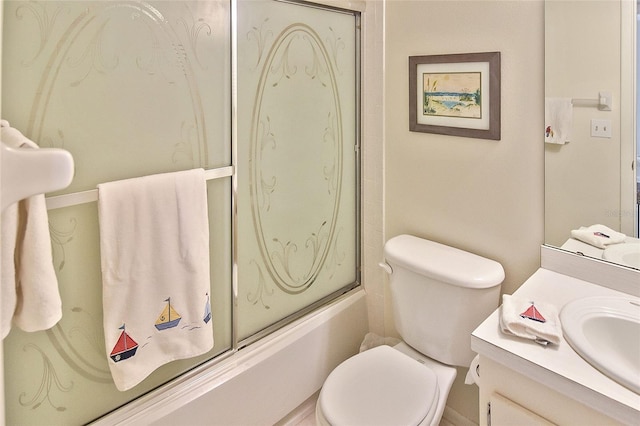 full bathroom featuring vanity, toilet, and shower / bath combination with glass door