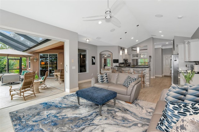 living room featuring a healthy amount of sunlight, high vaulted ceiling, ceiling fan, and light hardwood / wood-style floors