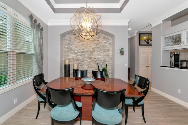 dining space with ornamental molding, plenty of natural light, and an inviting chandelier