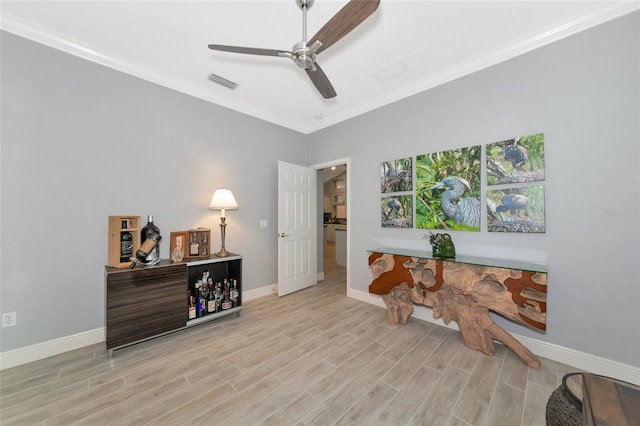 office with crown molding, ceiling fan, and light hardwood / wood-style flooring