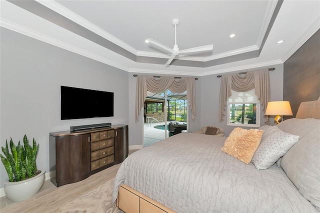 bedroom with light hardwood / wood-style flooring, access to outside, a raised ceiling, and crown molding