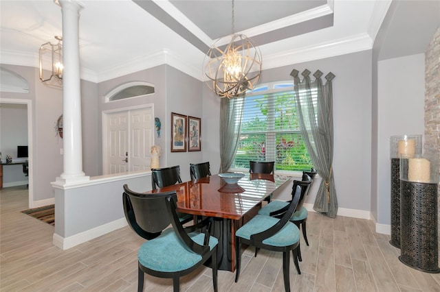 dining space featuring light wood-type flooring, ornate columns, and a notable chandelier