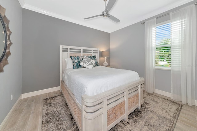 bedroom with light wood-type flooring, crown molding, and ceiling fan