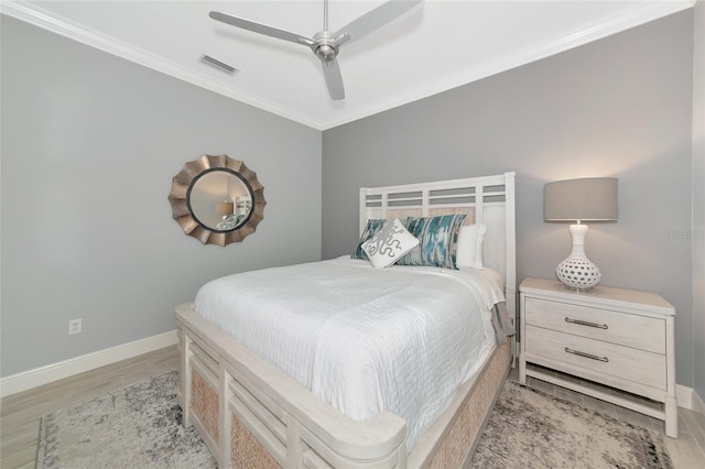 bedroom featuring crown molding, ceiling fan, and light hardwood / wood-style flooring