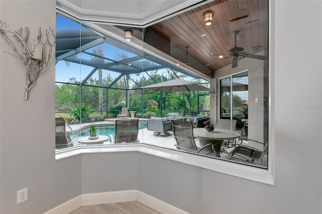 sunroom / solarium with a patio and ceiling fan