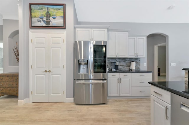 kitchen with backsplash, light hardwood / wood-style flooring, white cabinets, and stainless steel refrigerator with ice dispenser