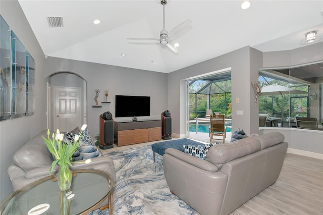 living room with vaulted ceiling, ceiling fan, and light hardwood / wood-style flooring