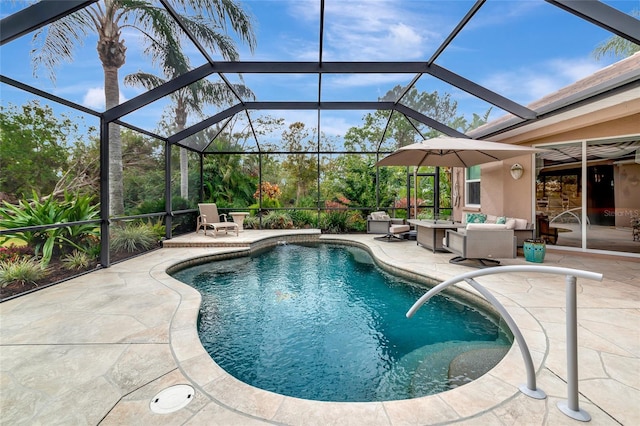 view of pool with an outdoor hangout area, glass enclosure, and a patio area