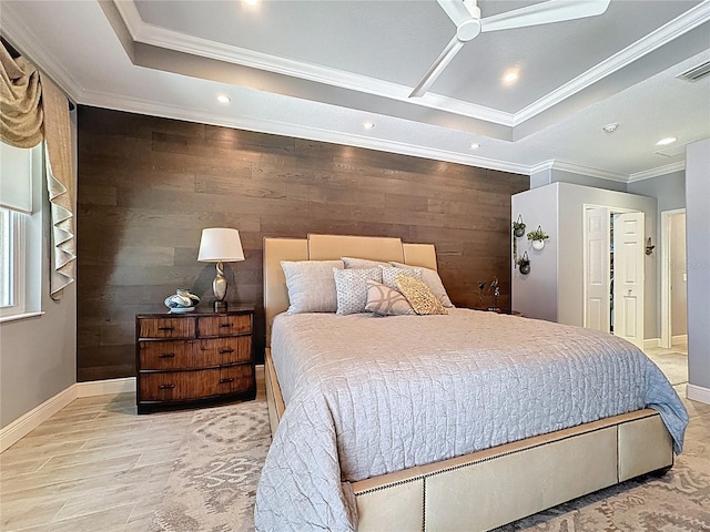 bedroom featuring crown molding, baseboards, wooden walls, recessed lighting, and a tray ceiling