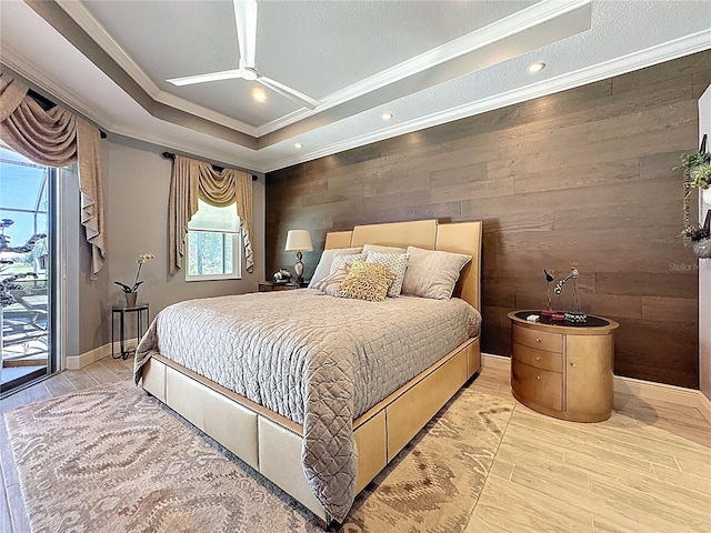 bedroom with crown molding, wood walls, access to exterior, baseboards, and wood finished floors