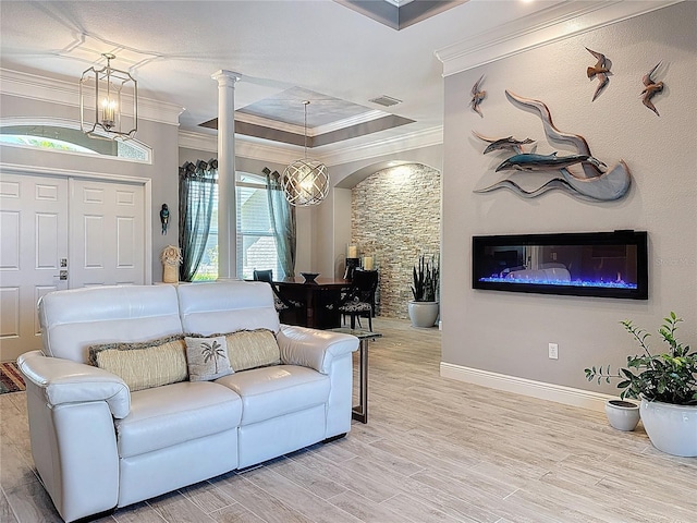 living area with crown molding, baseboards, decorative columns, and light wood-style floors