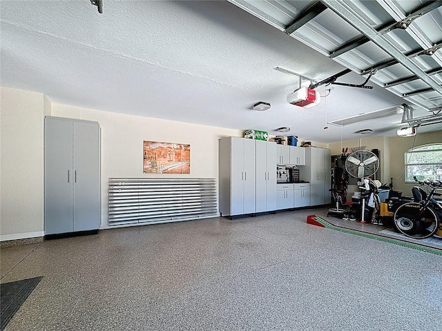garage with baseboards and a garage door opener