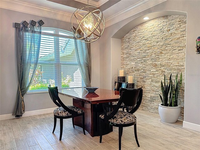 dining space with baseboards, an inviting chandelier, ornamental molding, and wood finished floors