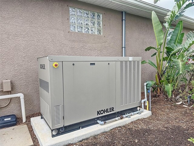 details featuring a power unit and stucco siding