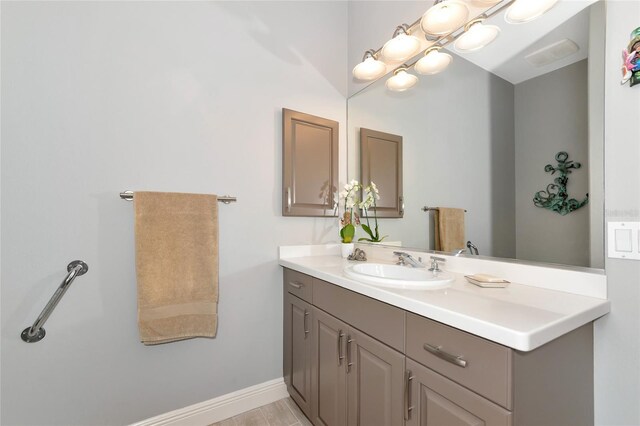 bathroom with vanity and baseboards