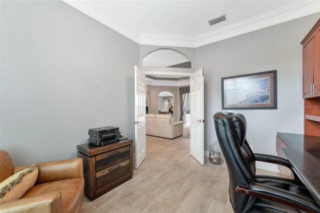 office featuring french doors, visible vents, baseboards, light wood finished floors, and ornamental molding
