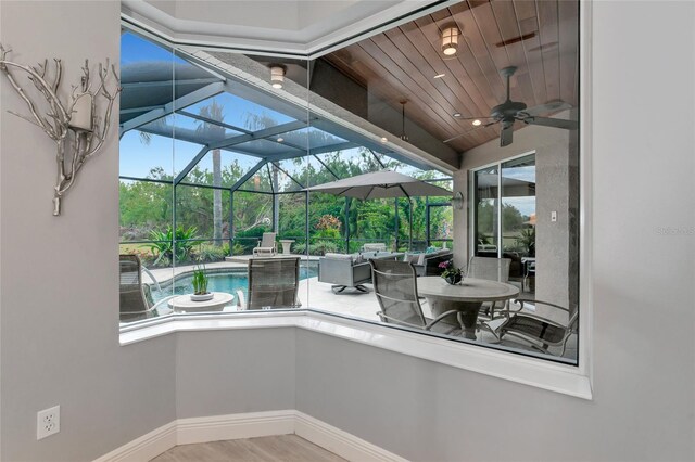 exterior space featuring a ceiling fan, outdoor lounge area, a lanai, and an outdoor pool
