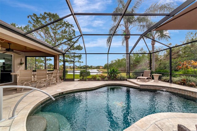 outdoor pool with a patio, ceiling fan, a lanai, and outdoor dry bar