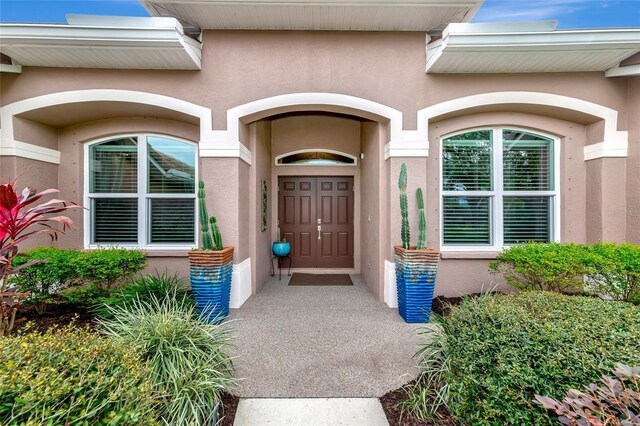 entrance to property featuring stucco siding