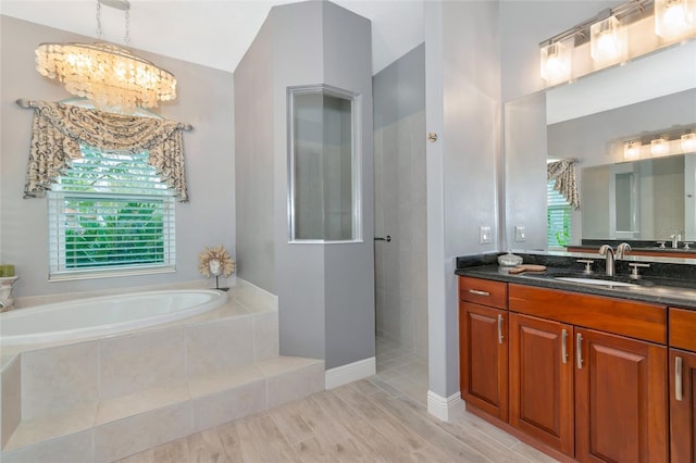 16806 5th Ter NE, Bradenton, FL 34212 - bathroom with a garden tub, plenty of natural light, a chandelier, vanity, and lofted ceiling