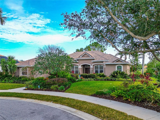 16806 5th Ter NE, Bradenton, FL 34212 - mediterranean / spanish house featuring stucco siding and a front lawn