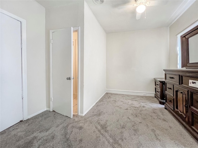 interior space with ceiling fan and light colored carpet