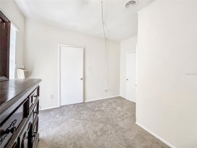 unfurnished dining area with light carpet