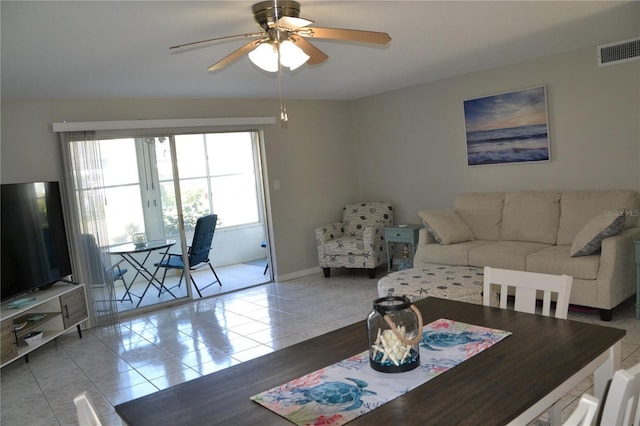 dining space featuring ceiling fan and tile patterned flooring