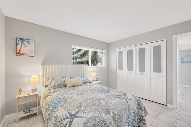 bedroom featuring light tile patterned floors and a closet