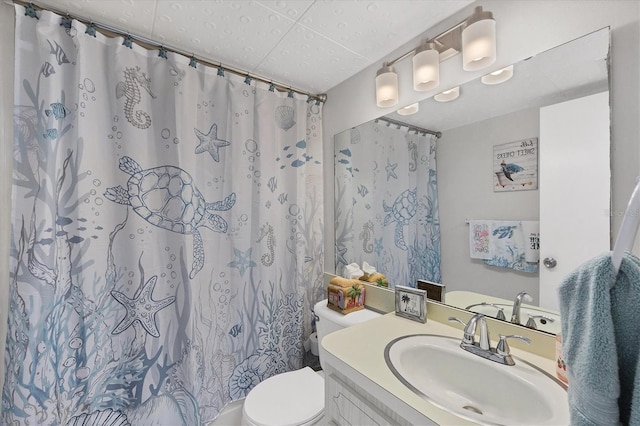 bathroom with vanity, walk in shower, a textured ceiling, and toilet