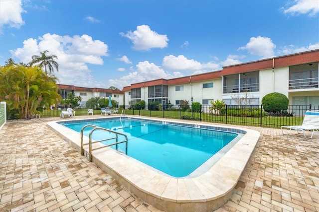 view of pool with a yard and a patio