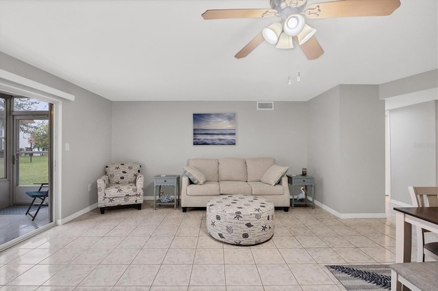 tiled living room with ceiling fan