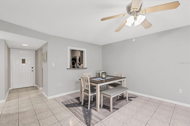 tiled dining room with ceiling fan