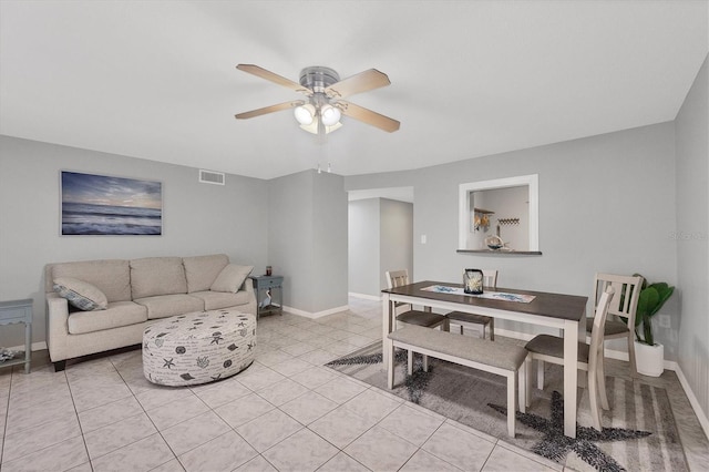 living room featuring light tile patterned floors and ceiling fan